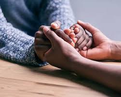 african american hands holding each other in prayer